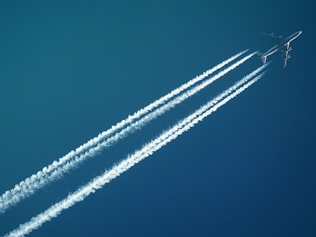 A picture of blue sky with an aeroplane in it