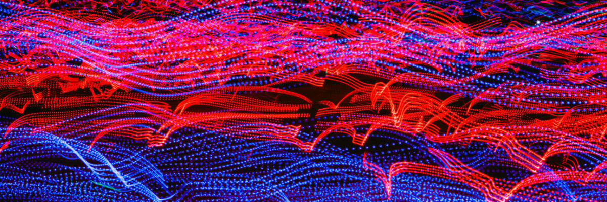 An abstract image of red and blue technical wave lines.